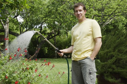Technician operating a stump grinder machine in Cleaners SW20